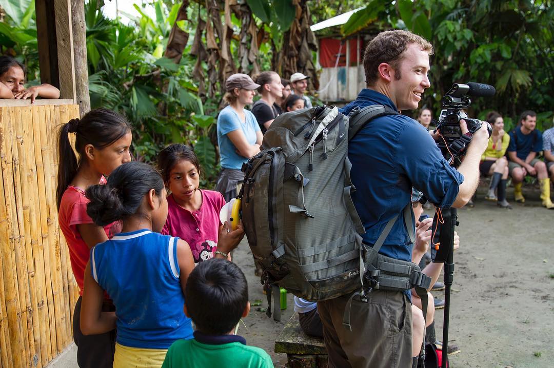 Curious Quechua kids in the community of Ahuano, Ecuador. ⠀ Ahuano is a small Quechua community located very close to #CasaDelSuizo lodge to the North of Napo river. ⠀ It took us a 15 minute boat ride from the lodge to the entrance of the community. The first to greet you are the local children, who offer you bracelets and figures crafted out of palm leafs in exchange for a few coins. ⠀ The guides then take you into the community, explaining their building techniques and a few general aspects of the Quechua lifestyle. They also show you the use they have for the termite nests you can easily find around the amazon, how they prepare their traditional Chicha drink, and how to shoot their blowguns. At the end you can buy a few crafts such as bracelets, necklaces and toys from the Ahuano artisans. ⠀ While this community in particular has been modernized a bit due to the influence of tourism (such as having a school and modern clothing), they still conserve their culture and traditions and are happy to share that with visitors. ⠀ Most of the people here speak only their native Quechua language, and it is through the guides of the lodge (some of whom are from this community) that you communicate with them. They also remain curious of those things they’re not familiar with, as you can see in this photo of the kids playing with @filmmakermc’s #SunKingLamp, so that’s another tip on how to break the ice with them.